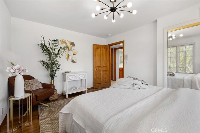 10703 Wheatland Ave, Sunland, CA 91040 - bedroom featuring an inviting chandelier and wood finished floors