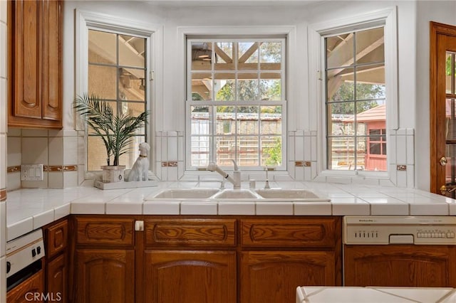 10703 Wheatland Ave, Sunland, CA 91040 - kitchen with a sink, plenty of natural light, and brown cabinets