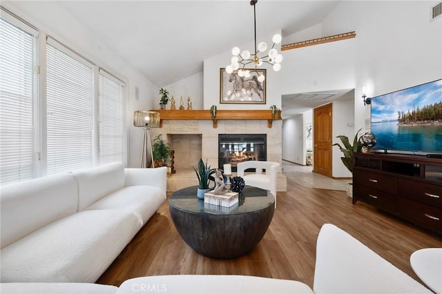 10703 Wheatland Ave, Sunland, CA 91040 - living area with vaulted ceiling, an inviting chandelier, visible vents, and wood finished floors