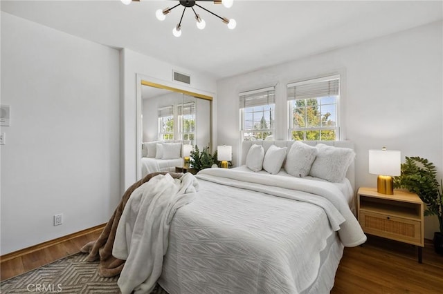 10703 Wheatland Ave, Sunland, CA 91040 - bedroom with wood finished floors, a closet, a chandelier, and visible vents