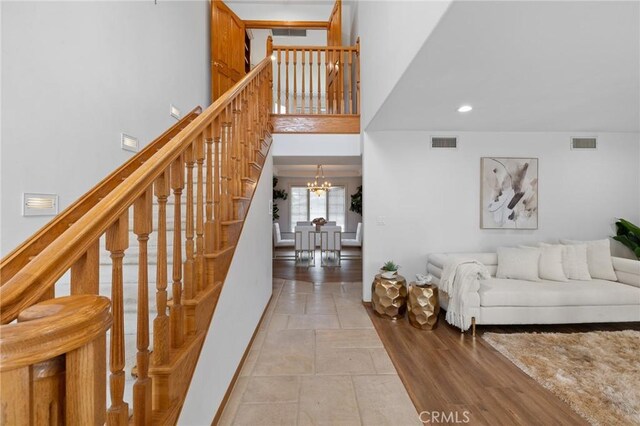10703 Wheatland Ave, Sunland, CA 91040 - stairs with recessed lighting, baseboards, visible vents, and an inviting chandelier