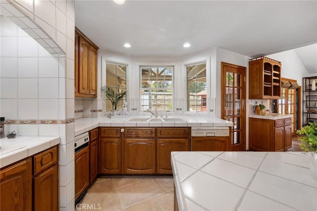 10703 Wheatland Ave, Sunland, CA 91040 - kitchen with a sink, brown cabinets, backsplash, and recessed lighting