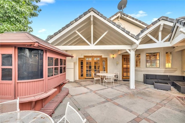 10703 Wheatland Ave, Sunland, CA 91040 - back of house featuring outdoor dining space, stucco siding, an outdoor living space, a patio area, and french doors