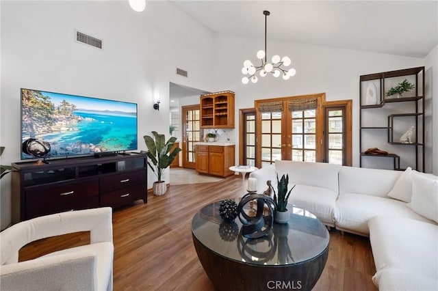 10703 Wheatland Ave, Sunland, CA 91040 - living area featuring a chandelier, visible vents, french doors, and light wood finished floors