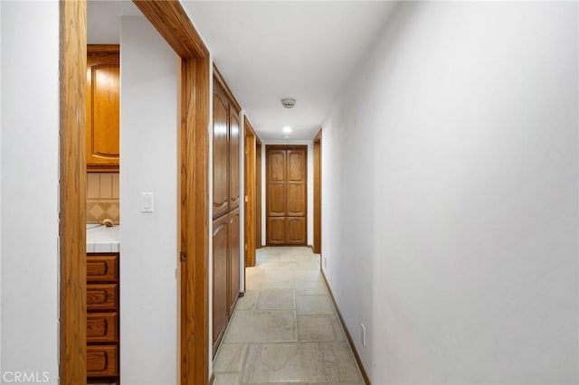10703 Wheatland Ave, Sunland, CA 91040 - hall with baseboards and stone finish flooring