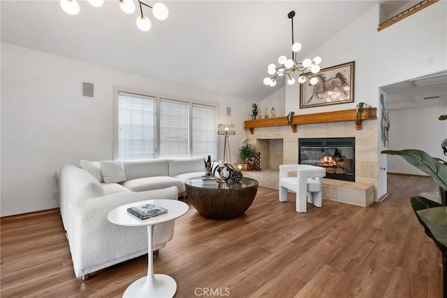 10703 Wheatland Ave, Sunland, CA 91040 - living area with a tiled fireplace, a notable chandelier, wood finished floors, and visible vents