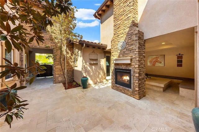 view of patio / terrace with an outdoor stone fireplace