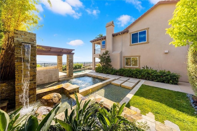 view of pool with a fenced in pool and an in ground hot tub
