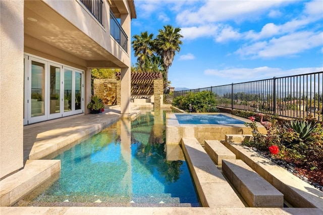 view of swimming pool with a fenced in pool, a fenced backyard, an in ground hot tub, a patio area, and french doors