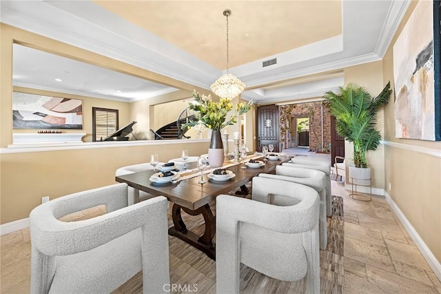 dining space featuring stone tile floors, baseboards, ornamental molding, and stairs