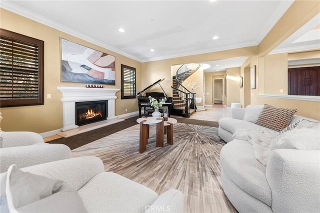 living room featuring stairway, baseboards, a glass covered fireplace, and recessed lighting