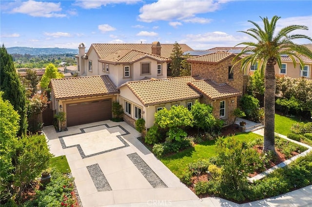 view of front of property with a tiled roof, a garage, stucco siding, and driveway