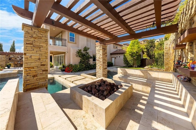 view of patio / terrace with an outdoor pool and an outdoor fire pit