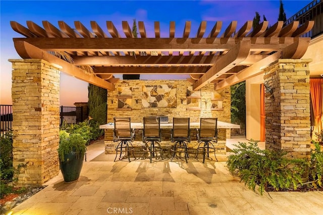 view of patio / terrace featuring a pergola and outdoor dry bar