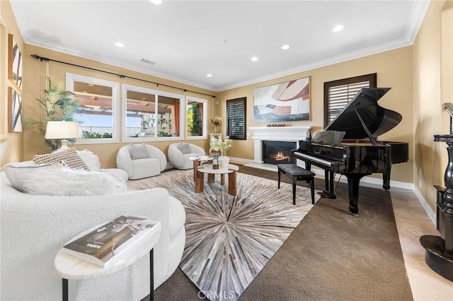 living area featuring crown molding, a glass covered fireplace, recessed lighting, and visible vents