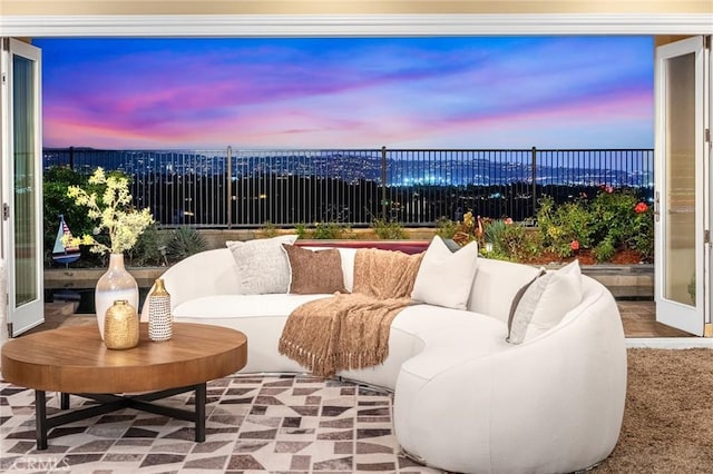 patio terrace at dusk featuring a fenced backyard and an outdoor living space