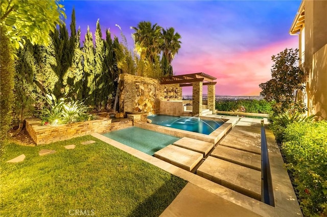 outdoor pool with a yard, a patio, and an in ground hot tub