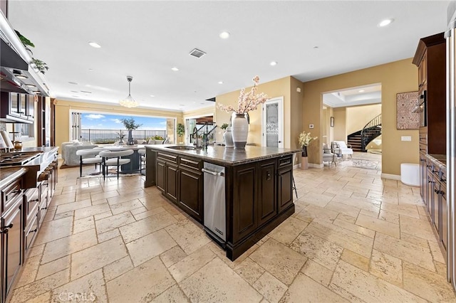 kitchen featuring open floor plan, recessed lighting, stone tile flooring, and visible vents