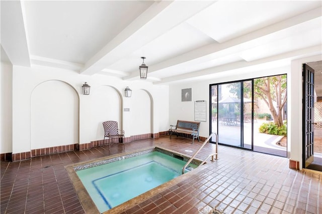 view of swimming pool featuring an indoor hot tub