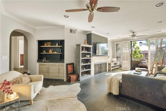 living room with visible vents, recessed lighting, ceiling fan, and arched walkways