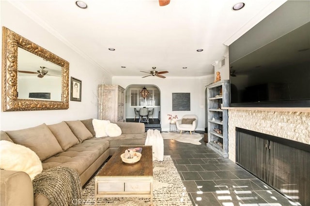 living area with recessed lighting, a ceiling fan, arched walkways, and ornamental molding