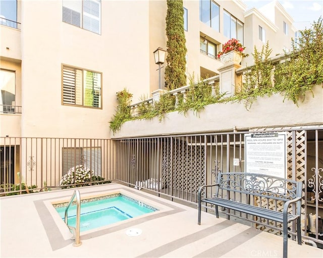 view of pool with a community hot tub