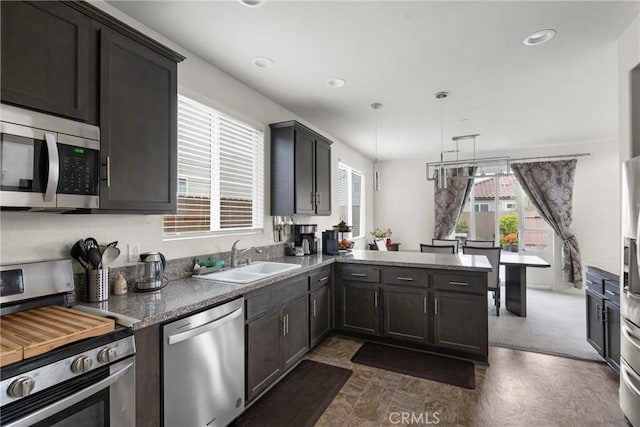 4575 Castillo Dr, Guadalupe, CA 93434 - kitchen featuring stainless steel appliances, a sink, healthy amount of natural light, a peninsula, and recessed lighting