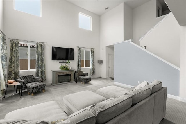 4575 Castillo Dr, Guadalupe, CA 93434 - living area with a high ceiling, light colored carpet, stairs, a fireplace, and baseboards