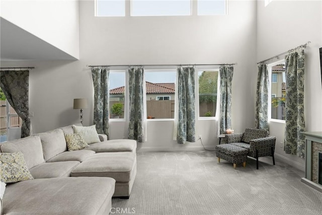 4575 Castillo Dr, Guadalupe, CA 93434 - living room with a towering ceiling, carpet floors, baseboards, and plenty of natural light