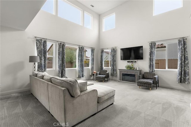 4575 Castillo Dr, Guadalupe, CA 93434 - living area featuring carpet, a high ceiling, a fireplace, and baseboards