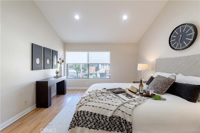 bedroom with baseboards, recessed lighting, wood finished floors, and vaulted ceiling