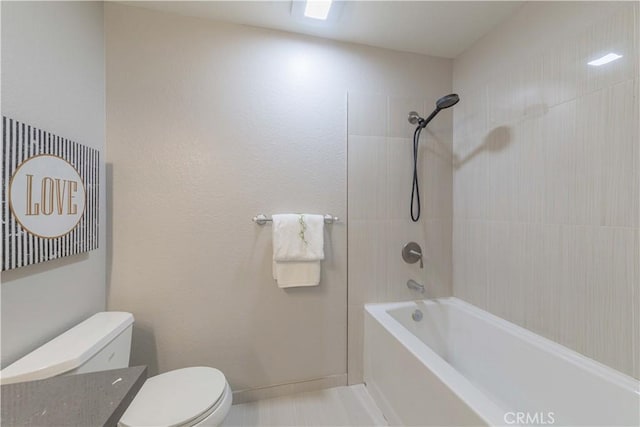 bathroom featuring tile patterned floors, bathing tub / shower combination, and toilet