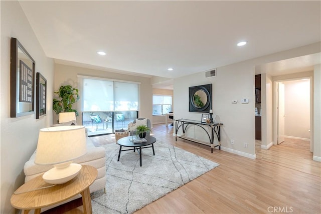 living area featuring recessed lighting, baseboards, visible vents, and light wood-style flooring