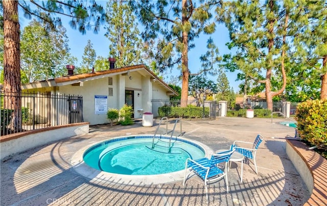 view of pool with a patio area and fence