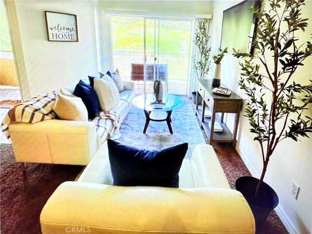 carpeted living room with baseboards