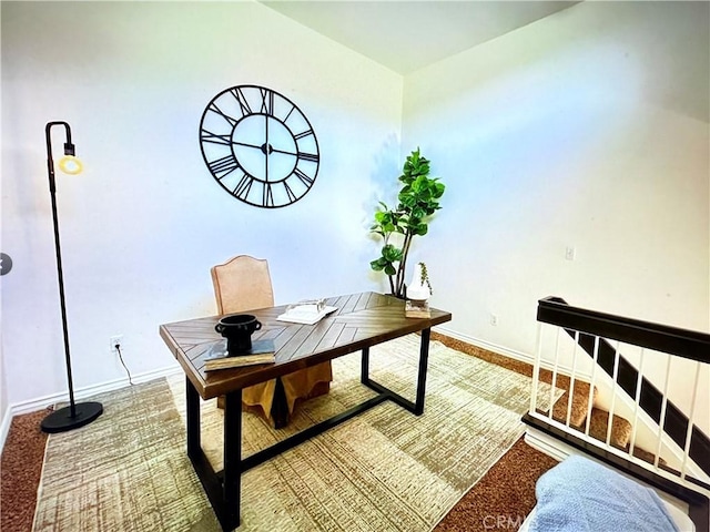 carpeted home office featuring baseboards