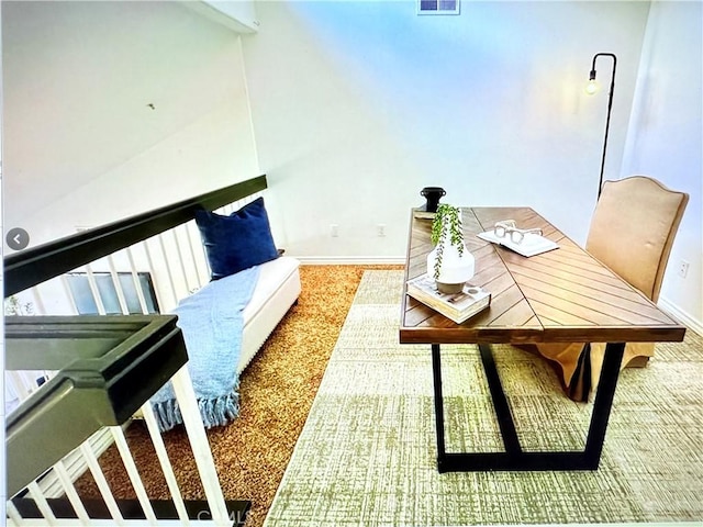 carpeted office space with baseboards and visible vents