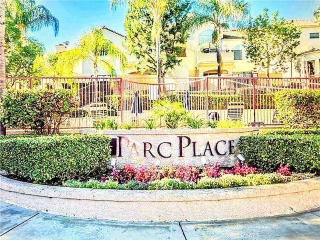 community / neighborhood sign featuring fence