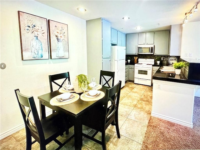 dining space with light tile patterned floors and recessed lighting