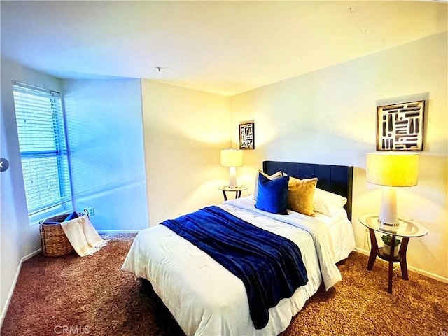 carpeted bedroom featuring baseboards
