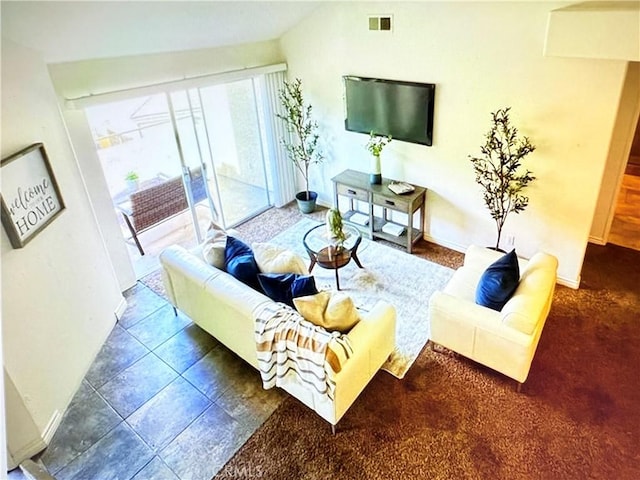 living room featuring baseboards, visible vents, and tile patterned flooring