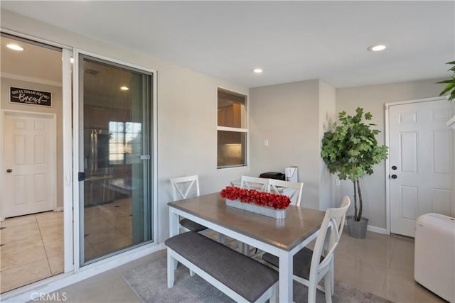 dining room with light tile patterned floors, baseboards, and recessed lighting