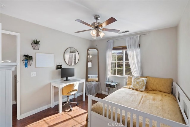 bedroom featuring radiator heating unit, a ceiling fan, baseboards, wood finished floors, and visible vents