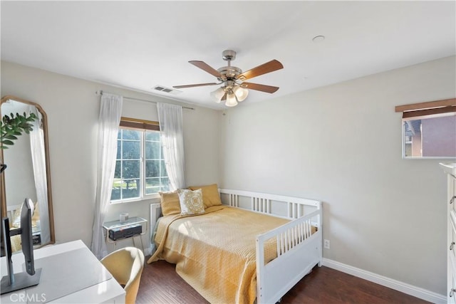 bedroom featuring visible vents, dark wood-style flooring, ceiling fan, and baseboards