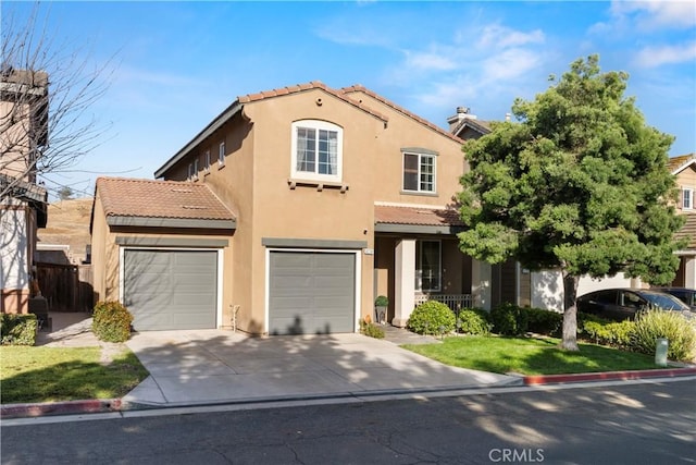 view of front of house featuring a tiled roof, driveway, and stucco siding