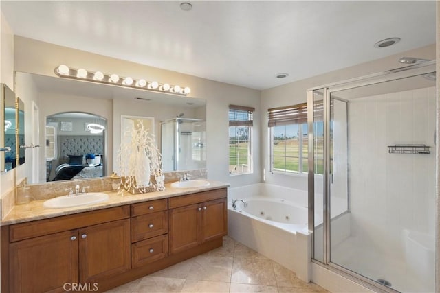 bathroom with connected bathroom, a whirlpool tub, a shower stall, and a sink