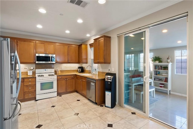 6239 Longmeadow St, Riverside, CA 92505 - kitchen featuring appliances with stainless steel finishes, brown cabinets, crown molding, light stone counters, and recessed lighting