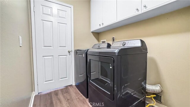 24939 Coral Canyon Rd, Corona, CA 92883 - washroom with washer and dryer, cabinet space, wood finished floors, and baseboards