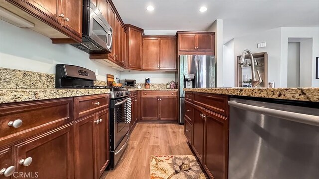 24939 Coral Canyon Rd, Corona, CA 92883 - kitchen featuring stainless steel appliances, light wood-type flooring, recessed lighting, light stone countertops, and a sink