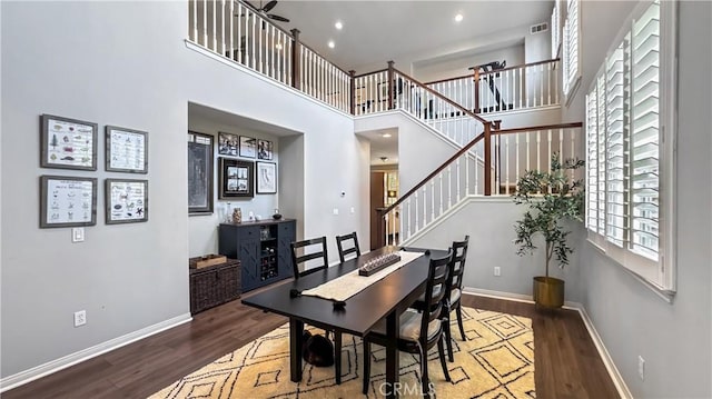 24939 Coral Canyon Rd, Corona, CA 92883 - dining space featuring wood finished floors, stairs, a towering ceiling, baseboards, and recessed lighting